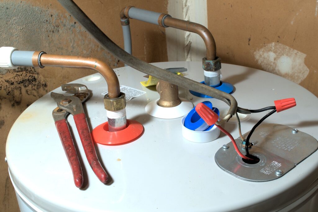 Black Specks in Hot Water? How to Tell If It Is the Anode Rod, Hoses, or Tank